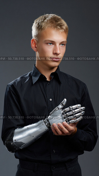 Young man holding bionic prosthetic arm, embracing future technology. Стоковое AI-изображение, AI-художник Юрий Поздников / Фотобанк Лори