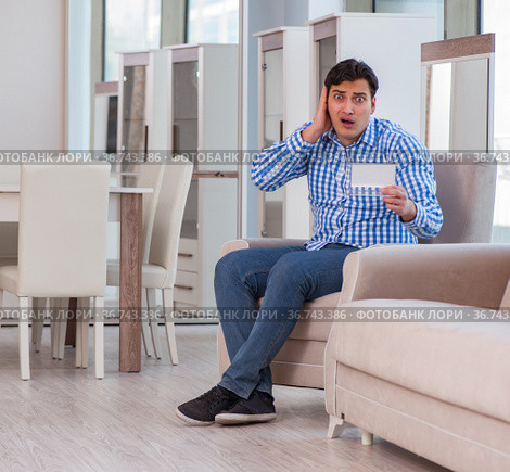 Young man shopping in furniture store. Стоковое фото, фотограф Elnur / Фотобанк Лори