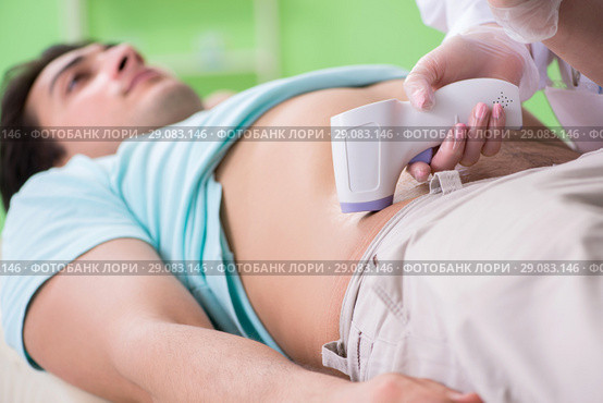 Young man visiting radiologyst for ultrasound procedure. Стоковое фото, фотограф Elnur / Фотобанк Лори