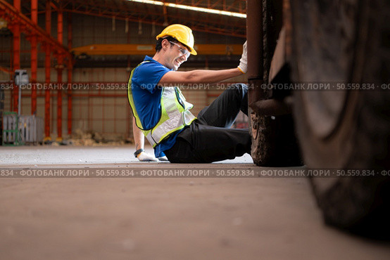 Young man working in a steel industry factory. He was critically hurt when a forklift ran over his leg and had to be transported to the hospital. Стоковое фото, агентство Ingram Publishing / Фотобанк Лори