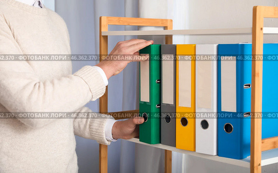 Young man working with documents in office. Стоковое фото, фотограф Pixel_shot / Фотобанк Лори