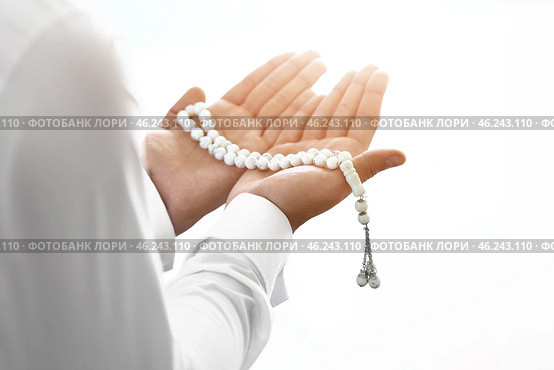 Young Muslim man praying indoors. Стоковое фото, фотограф Pixel_shot / Фотобанк Лори