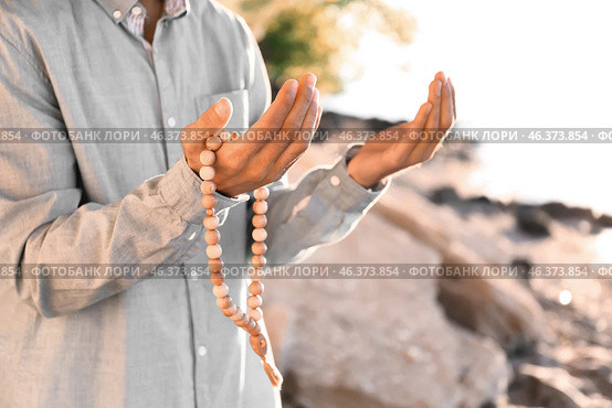 Young Muslim man praying outdoors. Стоковое фото, фотограф Pixel_shot / Фотобанк Лори
