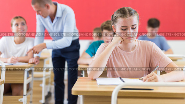 Young students sitting at desks in classroom. Стоковое фото, фотограф Яков Филимонов / Фотобанк Лори