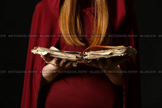 Young witch with spell book on dark background, closeup. Стоковое фото, фотограф Pixel_shot / Фотобанк Лори