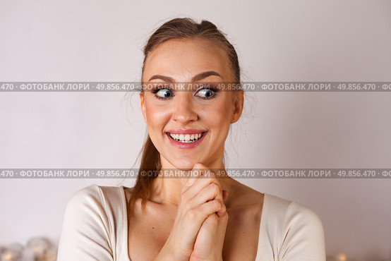 Young Woman Expresses Joy and Excitement in a Bright Studio Setting During a Creative Moment. Стоковое фото, фотограф Aleksandr Golubev / Фотобанк Лори