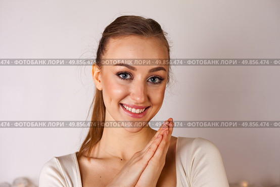 Young Woman Expresses Joy and Positivity in a Bright Studio Setting. Стоковое фото, фотограф Aleksandr Golubev / Фотобанк Лори