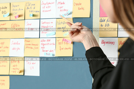 Young woman near scrum task board in office. Стоковое фото, фотограф Pixel_shot / Фотобанк Лори