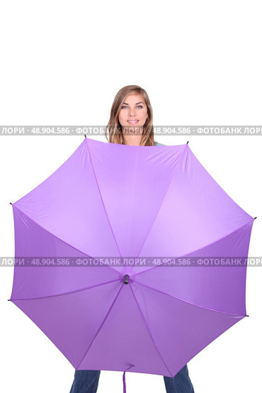Young woman posing with an open umbrella in bright purple. Стоковое фото, агентство Ingram Publishing / Фотобанк Лори