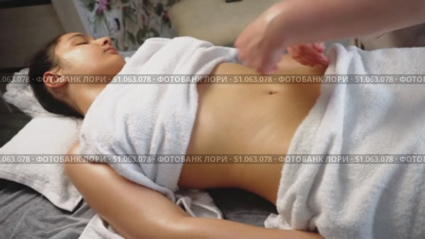 Young woman receiving stomach massage in spa salon. Closeup. Стоковое видео, видеограф Владислав Тригуб / Фотобанк Лори