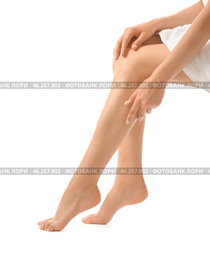 Young woman showing silky skin on legs after epilation against white background. Стоковое фото, фотограф Pixel_shot / Фотобанк Лори