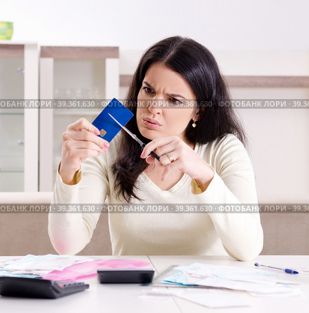 Young woman with receipts in budget planning concept. Стоковое фото, фотограф Elnur / Фотобанк Лори