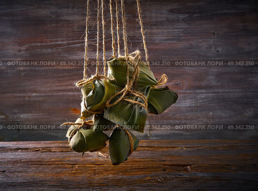 Zongzi Glutinous sticky Rice Dumplings recipe wrap with bamboo leaves asian food. Стоковое фото, агентство Ingram Publishing / Фотобанк Лори